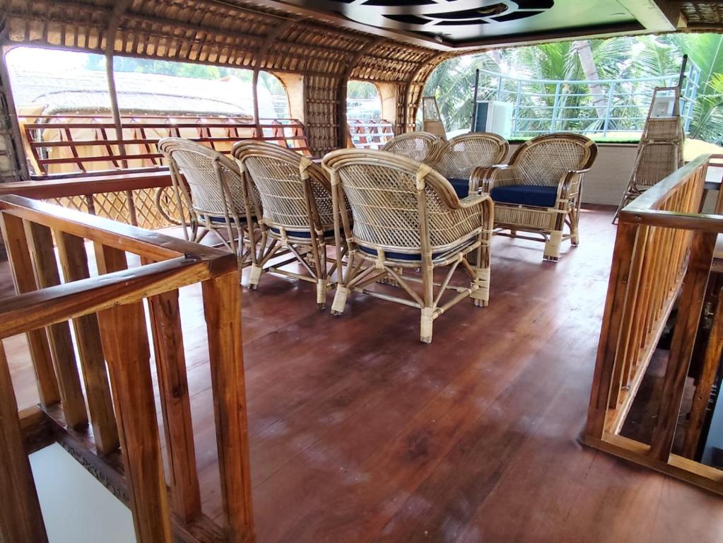 Upper deck of a luxury houseboat in Alleppey with seating area and backwater views