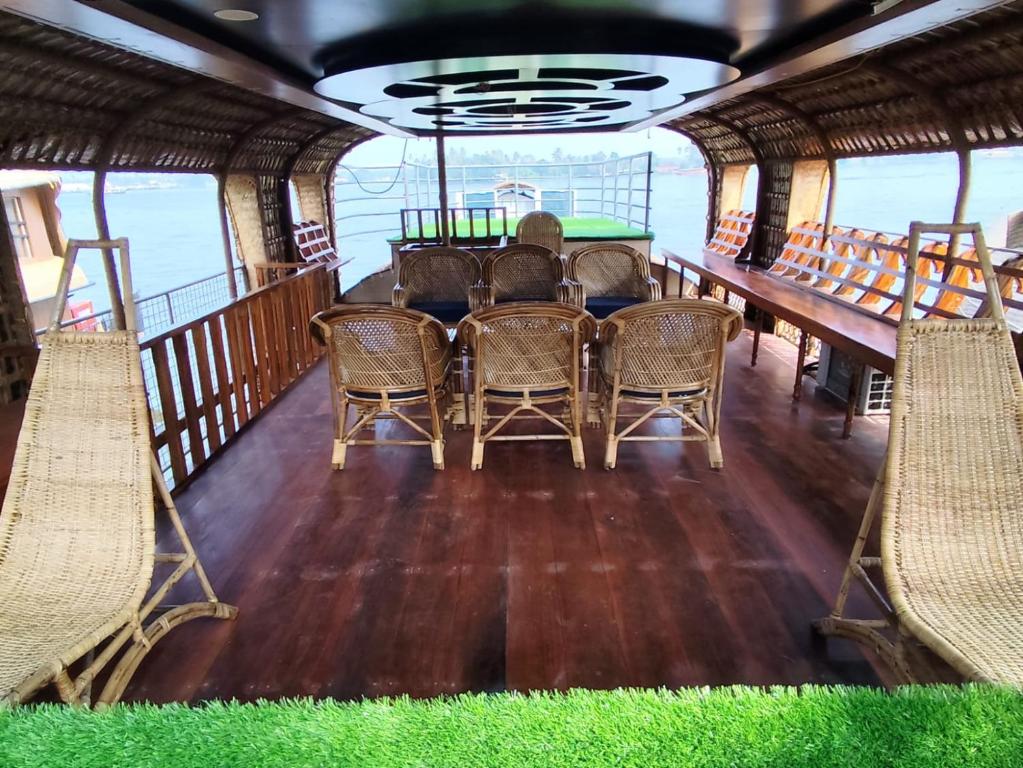 Interior of luxury houseboat living area with traditional Kerala woodwork and modern comfort